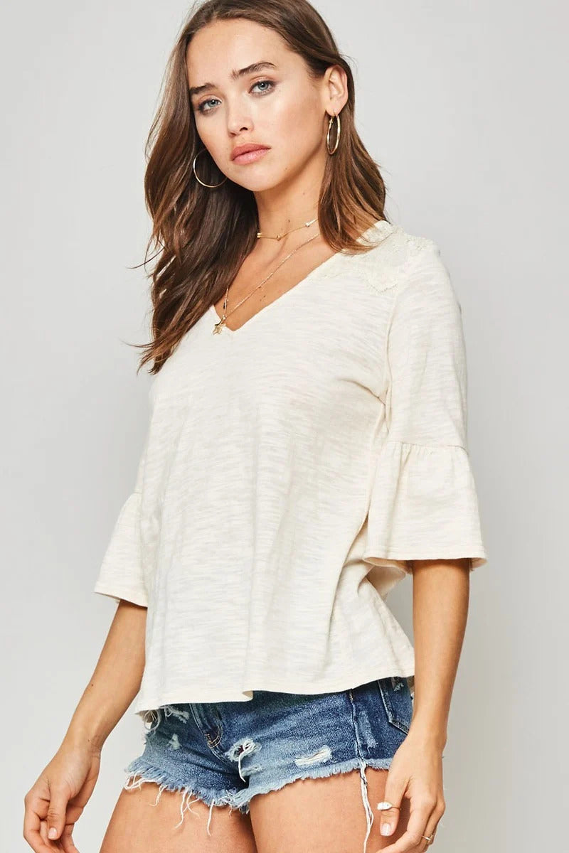 A Knit Top With Deep V Neckline And Yoke Design — Vanilla